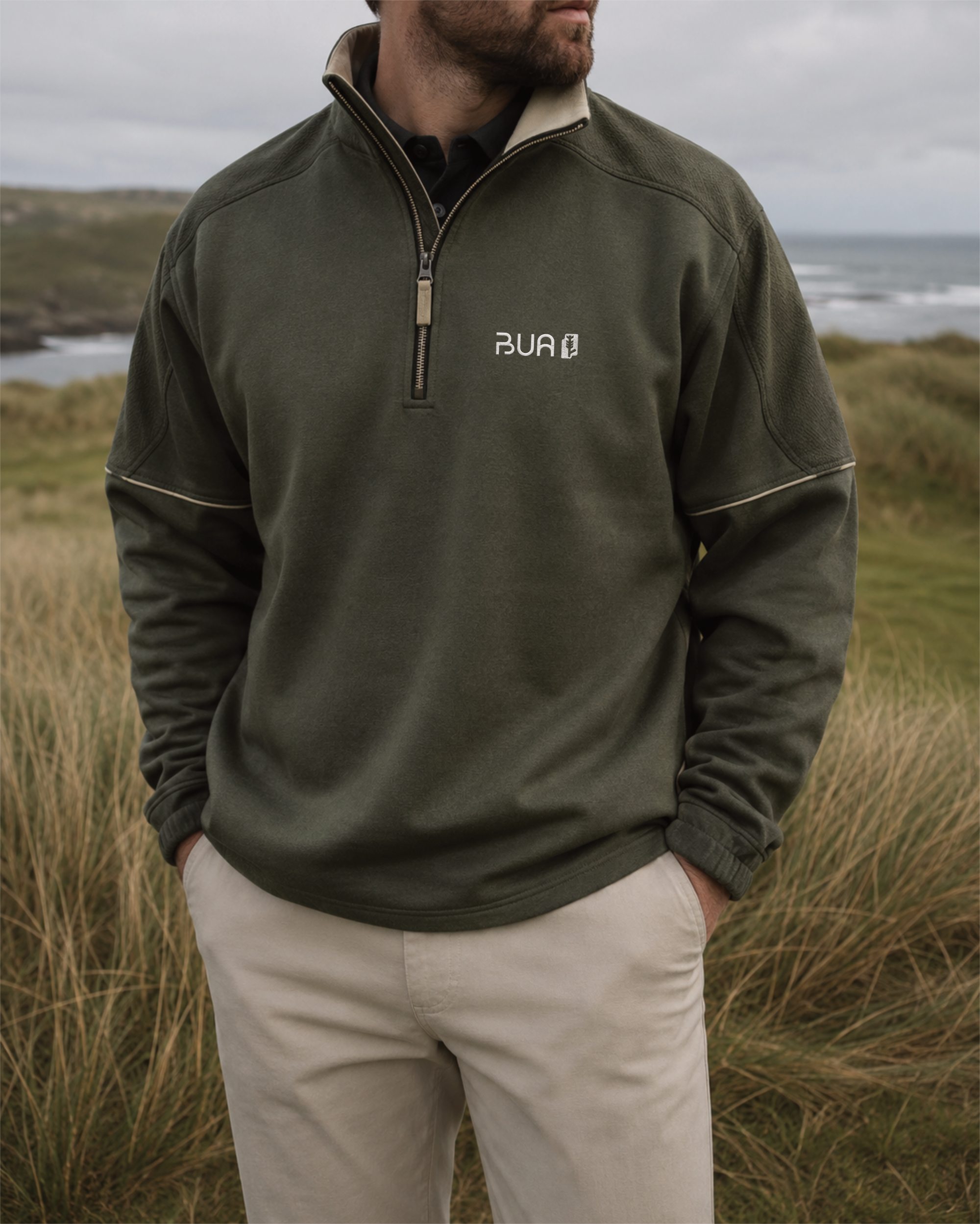 BUA quarter zip in Verdantra green, worn on the dunes of a links course.
